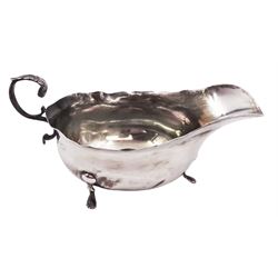 Edwardian silver sauce boat, of typical form, with shaped rim and acanthus capped flying scroll handle, upon three paw feet, hallmarked Wilson & Gill, London 1903, H7.4cm
