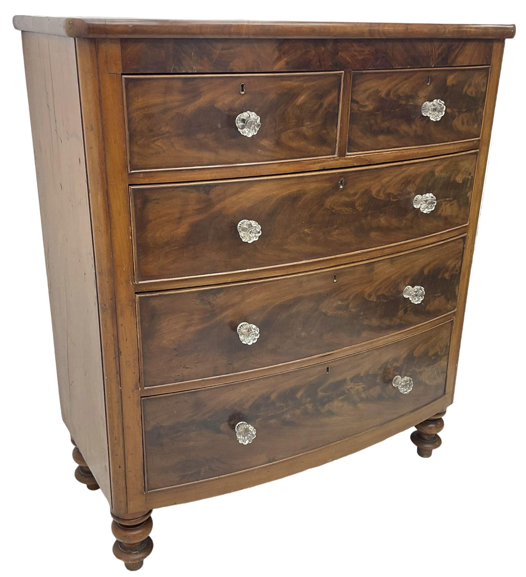 Victorian mahogany bow front chest, fitted with two short over three long graduating cock-beaded drawers, each with glass handles, raised on turned feet