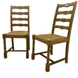 Set of six (4+2) beech dining chairs, high ladder back over drop-in rush seats, on ring turned supports united by H-stretcher