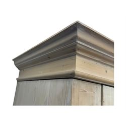 Victorian design lime-washed pine single wardrobe, projecting cornice over panelled door enclosing hanging rail, the lower section fitted with full-width drawer, on shaped plinth base