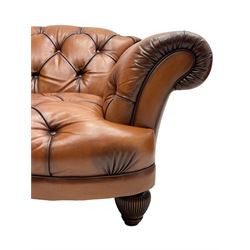 Tetrad - 'Oskar' armchair, Chesterfield shape with rolled arms, upholstered in buttoned tan leather, on turned and reed moulded feet 