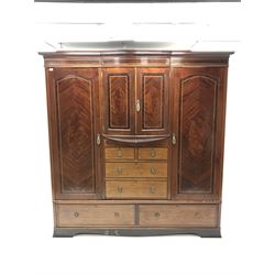 Edwardian mahogany triple wardrobe, centre bow front cupboard above drawers, two doors enclosing hanging space, drawers to base 