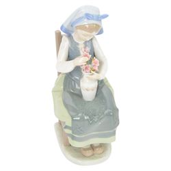 Three Lladro figures, comprising Spring Awakening 1283, Flower Harmony 1418 and Dutch girl with Tulips 5065