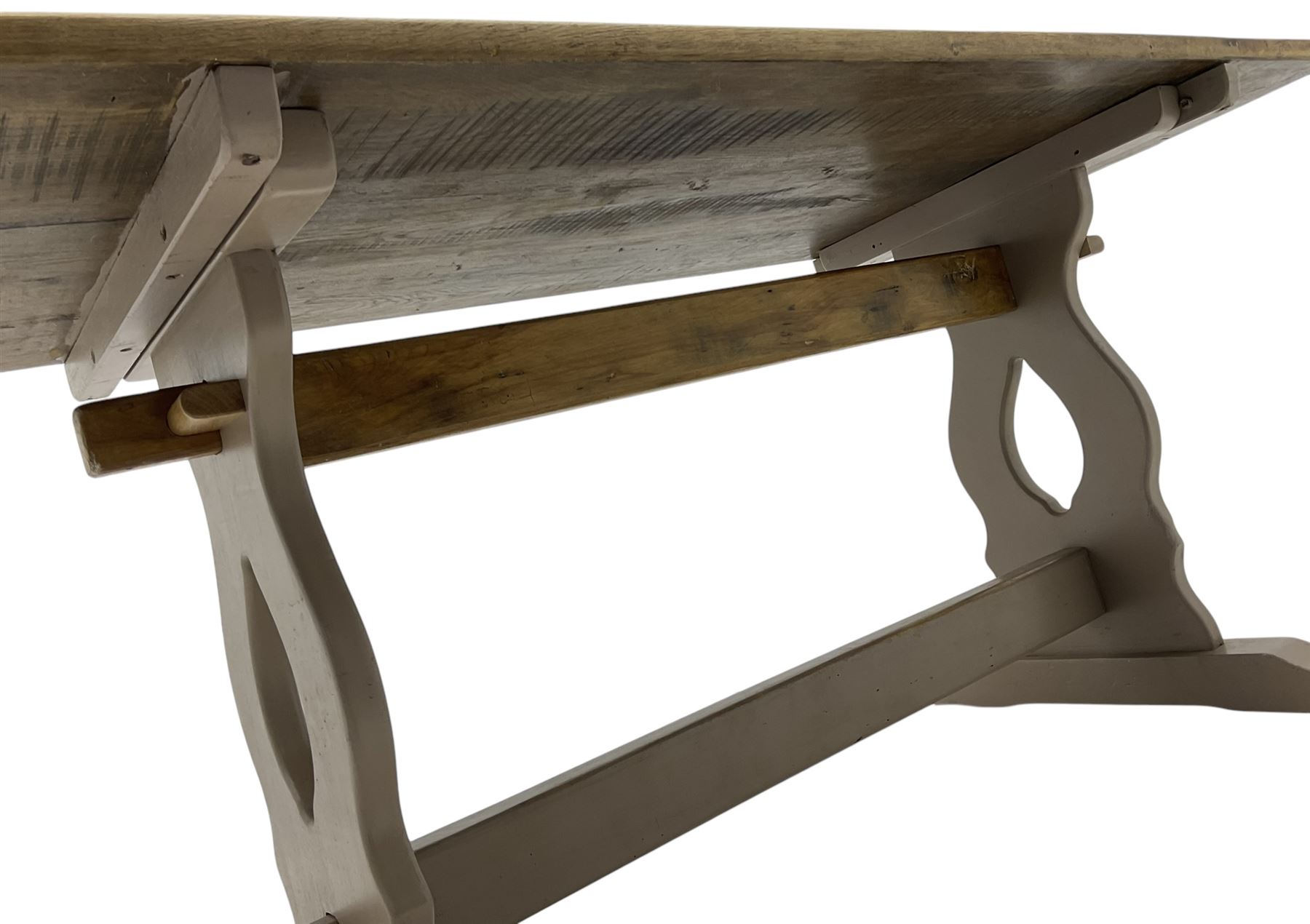 20th century oak refectory dining table, rectangular stripped top on painted base, shaped end supports on sledge feet united by two pegged stretchers