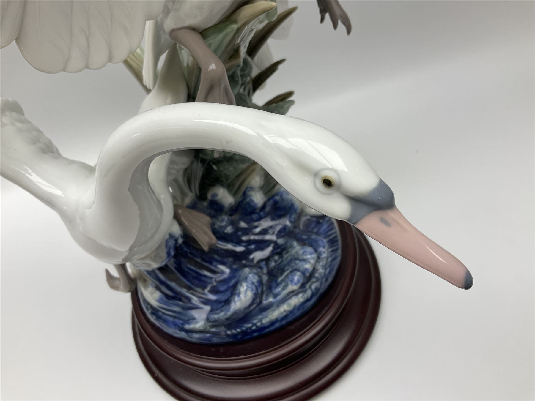 Large Lladro figure group, Swans Take Flight, modelled as two swans upon raised on circular wooden plinth, sculpted by Salvador Debon, H68cm