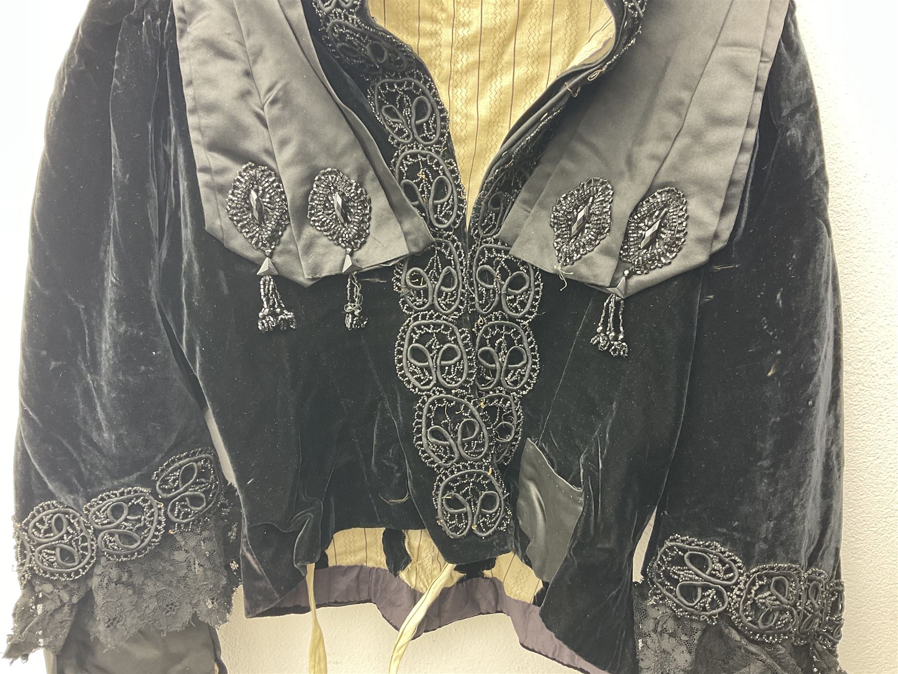 Victorian three piece mourning dress, with lace trim and jet beading, including velvet coat with satin collar panels and cuffs, the nipped waist with boning and slight flared peplum, heavily embellished beaded high neck collar, and ladies embroidered silk lined purse with gilt handle, mount and clasp