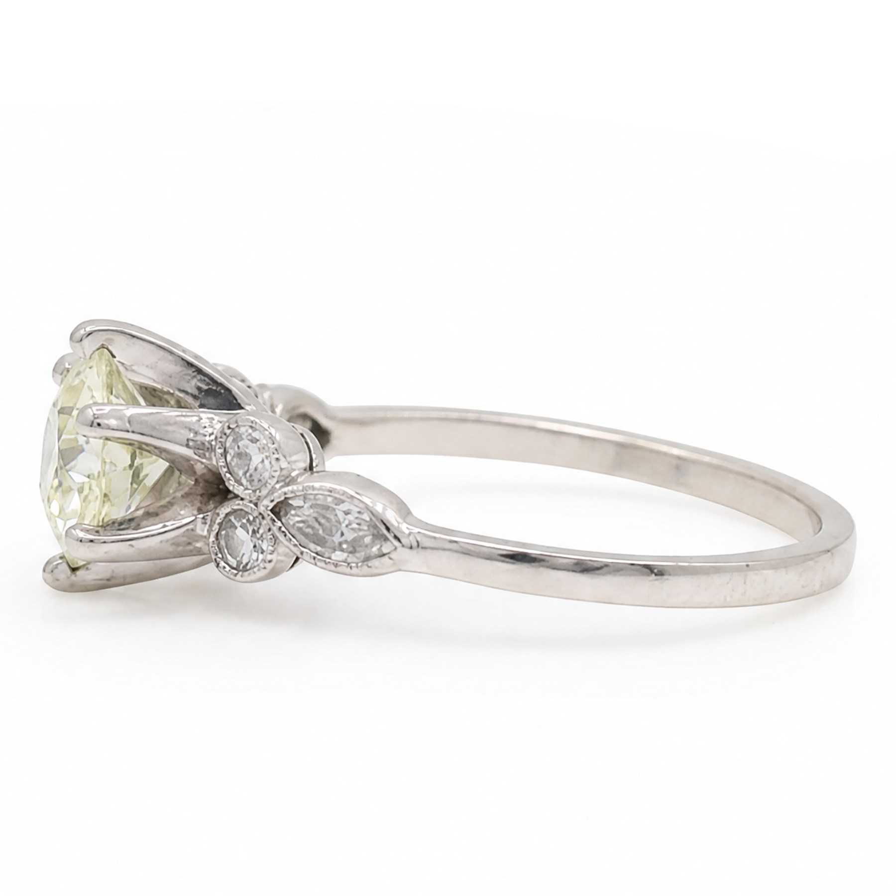Platinum diamond ring, six claw set with a single old cut diamond of approx 1.35 carat, each shoulder milgrain set with two single cut diamonds and a marquise cut diamond, stamped Plat