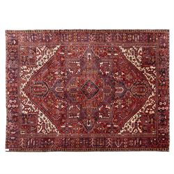 North West Persian Heriz hand-knotted carpet, madder red field with central bold angular s...