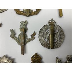 Twenty cap badges including Hertfordshire, Royal Sussex, Cambridgeshire, Hampshire, Notts and Derby, East Surrey, Herefordshire, South Lancashire, Devonshire, Bedfordshire, Durham Light Infantry etc (20)
