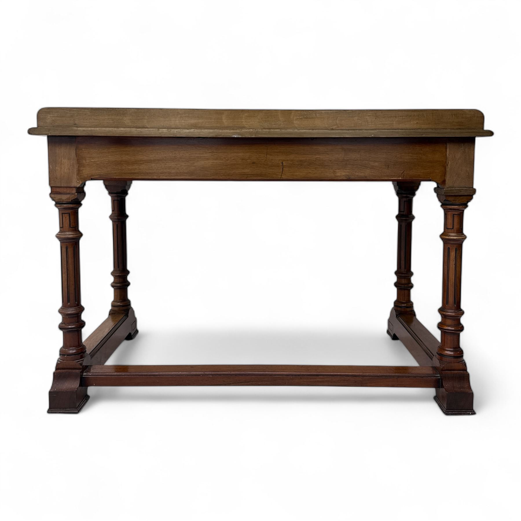 Late Victorian mahogany side table in the style of Gillows of Lancaster, mahogany rectangular top above two frieze drawers, the top edge of the right drawer stamped 'Gillow' and 'L486' with knob handles supported on turned stop and fluted legs with stretcher base on recessed castors

Provenance: The Davies-Cooke Collection from Gwysaney Hall, North Wales  