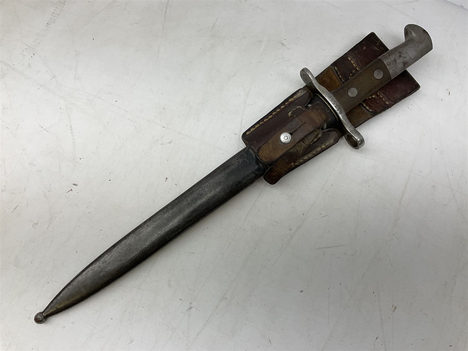 Schmidt-Rubin Model 1918 bayonet, the 30cm steel blade marked Elsener Schwyz, cross-piece numbered 813558; in steel scabbard with leather frog stamped E. Banga Sattler Selzac 67 L45.5cm overall; and Swiss Model 1957 SIG rifle bayonet by Wenger; in plastic scabbard with leather frog stamped E. Walty Sattlerei Baretswil 84 (2)