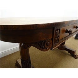  Regency rosewood rectangular Library table, two real and two false frieze drawers with anthemion carved mounts and handles, on lotus carved turned tapered supports with scroll carved paw feet, L137cm, W70cm, H75cm   