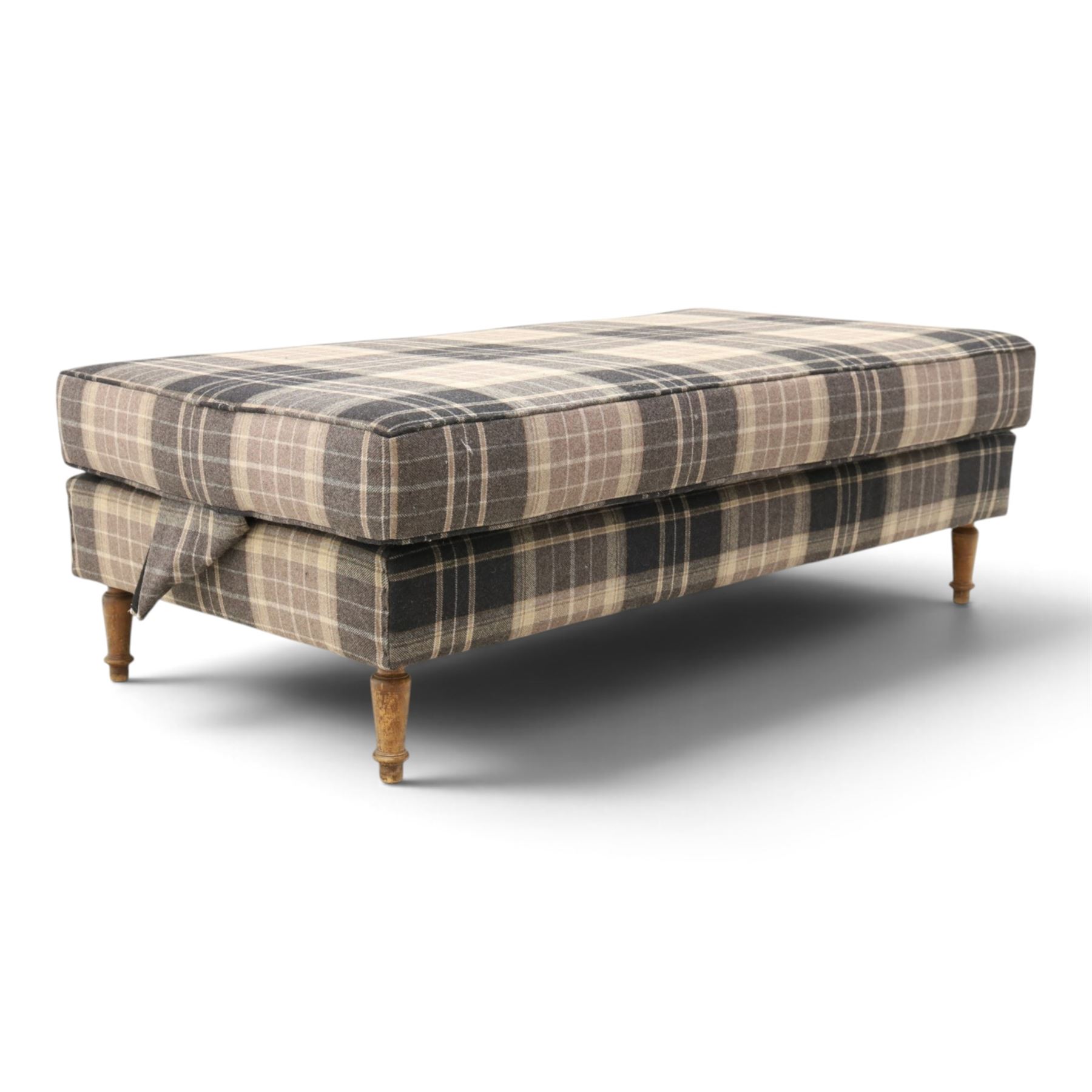 Large traditional design upholstered footstool, upholstered in checked fabric, with loose cushion, raised on a light turned supports 