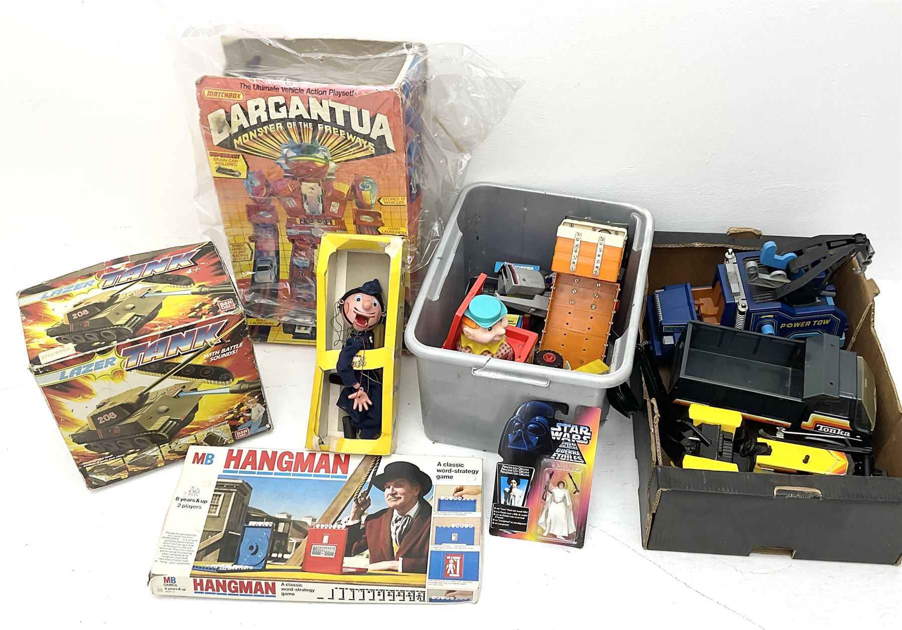 Pelham Puppet Police man with box, Star Wars Princess Leia figure by Kenner, boxed, Matchbox ‘Carguantua Monster of the Freeways’ playset, Bandai lazer tank, both boxed, Tonka trucks and other toys etc