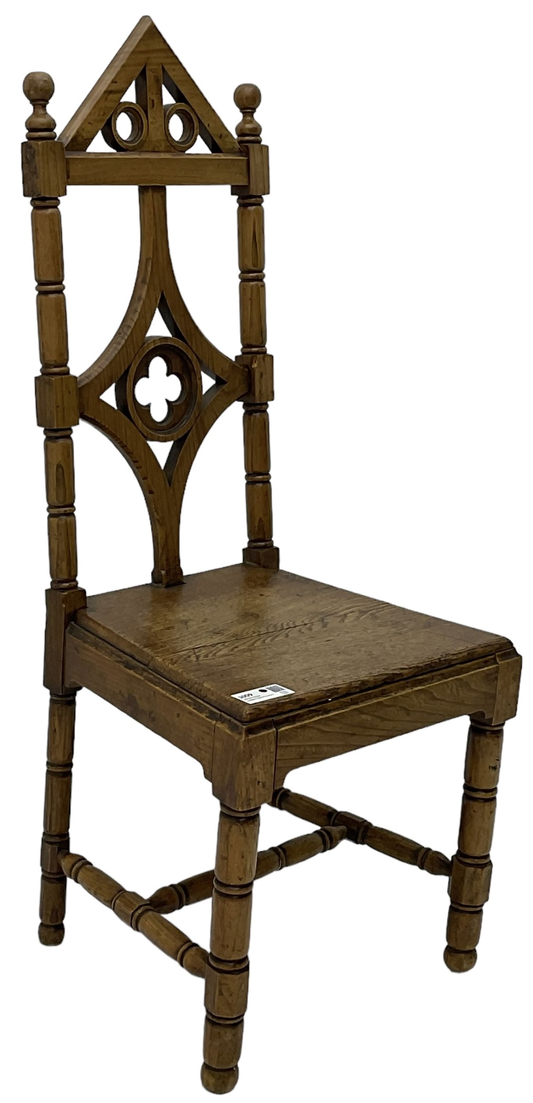 19th century Gothic elm chair, pointed cresting rail over shaped back with central quatrefoil roundel, on turned supports united by turned H-stretchers 