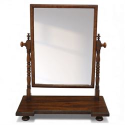Two early 20th century mahogany swing dressing mirrors, comprising one with arched rectangular plate in a moulded frame on shaped supports, flanked by two inlaid trinket drawers (H 69cm, W 88cm, D 20cm), together with another rectangular plate mirror on turned supports upon bun feet (H 58cm, W 48cm, D 23cm)
