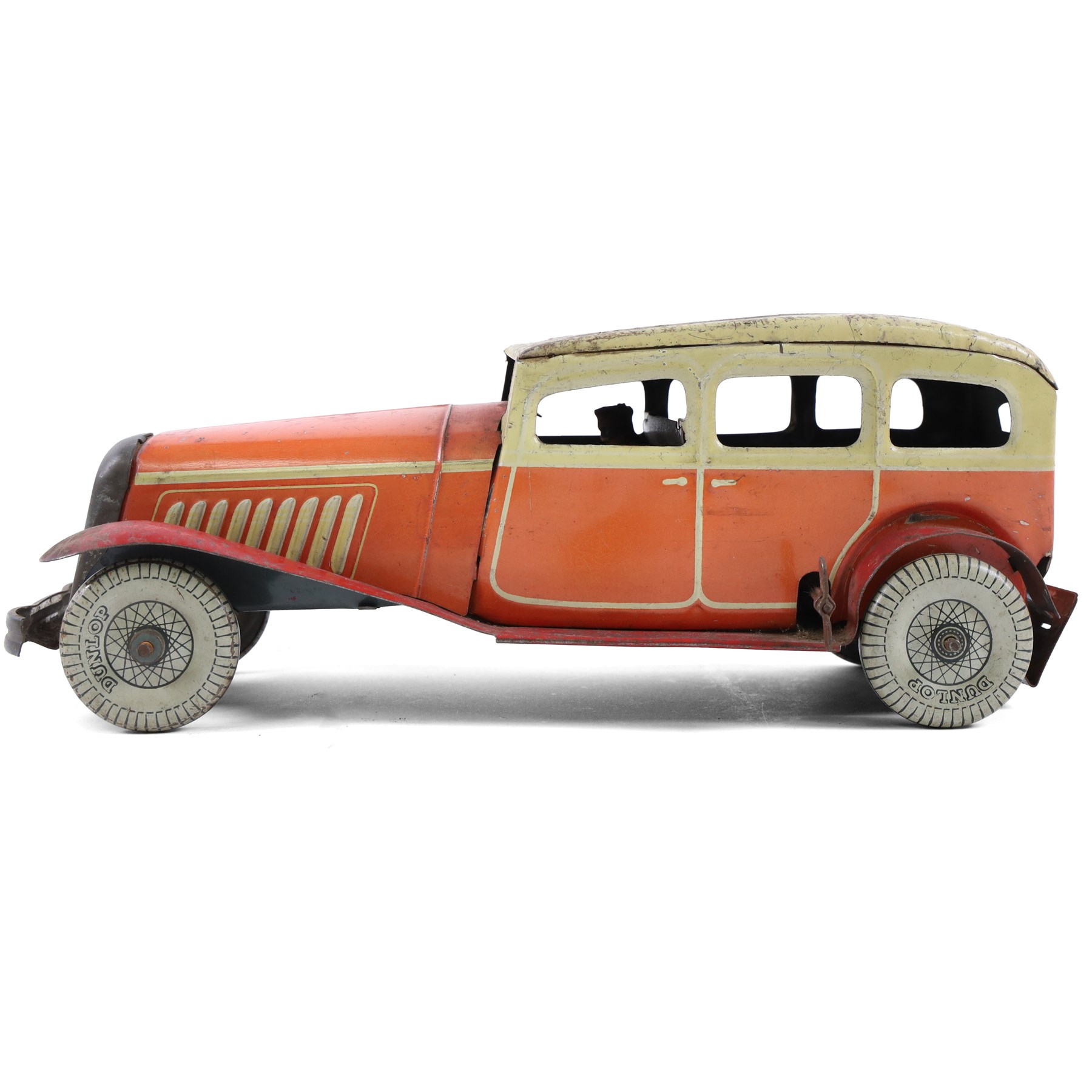 Mettoy tinplate clockwork Citroen saloon car, red orange body with cream roof and windows, with driver, Dunlop tyres and key, H9cm, L26cm