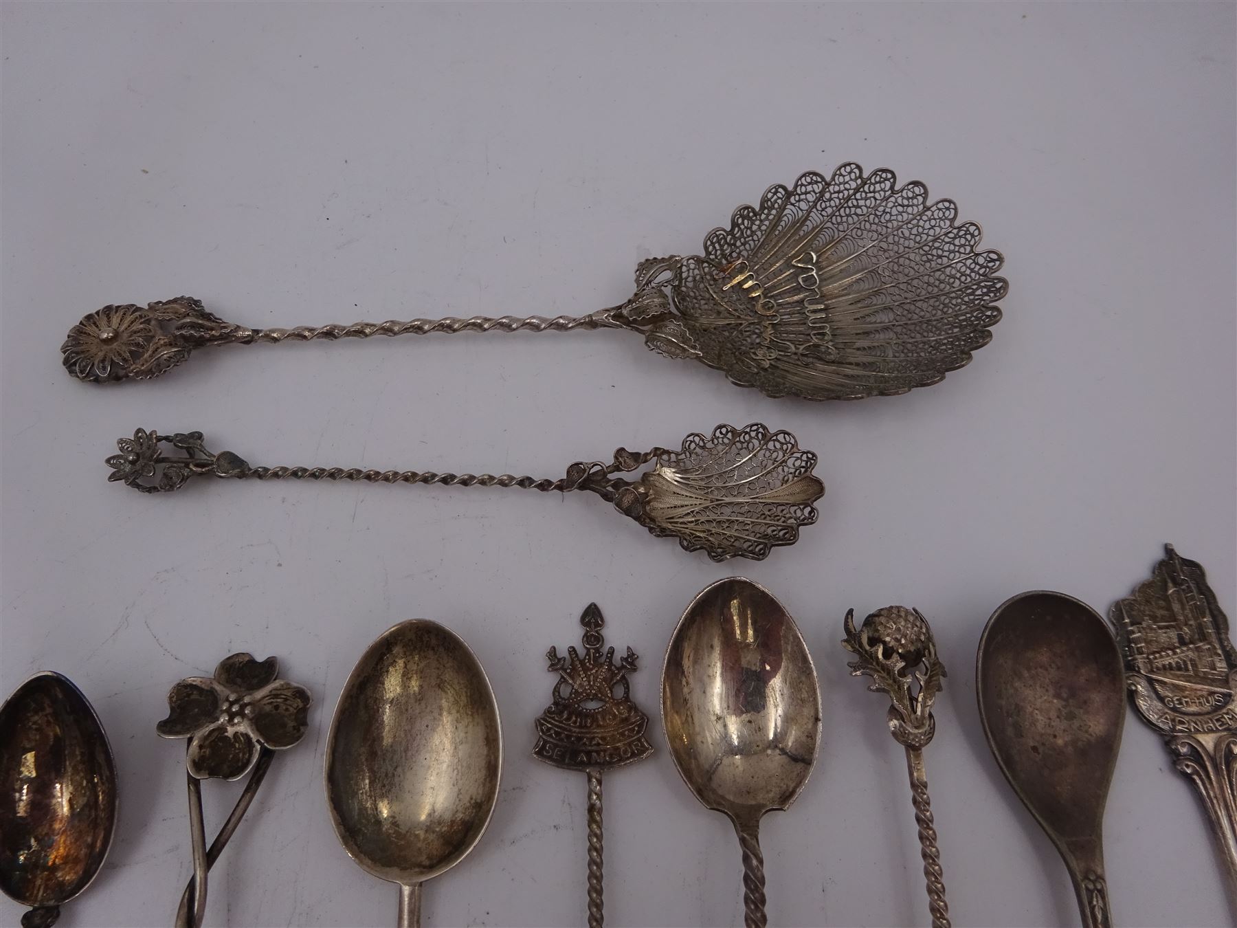 Set of six 1920s silver coffee bean spoons, together with a collection of silver souvenir and similar spoons, including two filigree examples, all tested or hallmarked