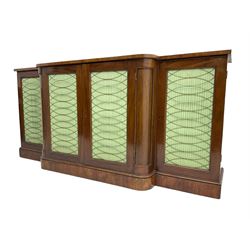 19th century mahogany break-front sideboard, raised brass gallery back with Greek key design, fitted with four cupboard doors, their pleated green fabric overlain with gilt metal grilles, lower moulded edge over plinth base