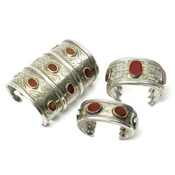 Silver Turkoman Tekke cuff with engraved decoration and inset with red stones L10cm, anoth...