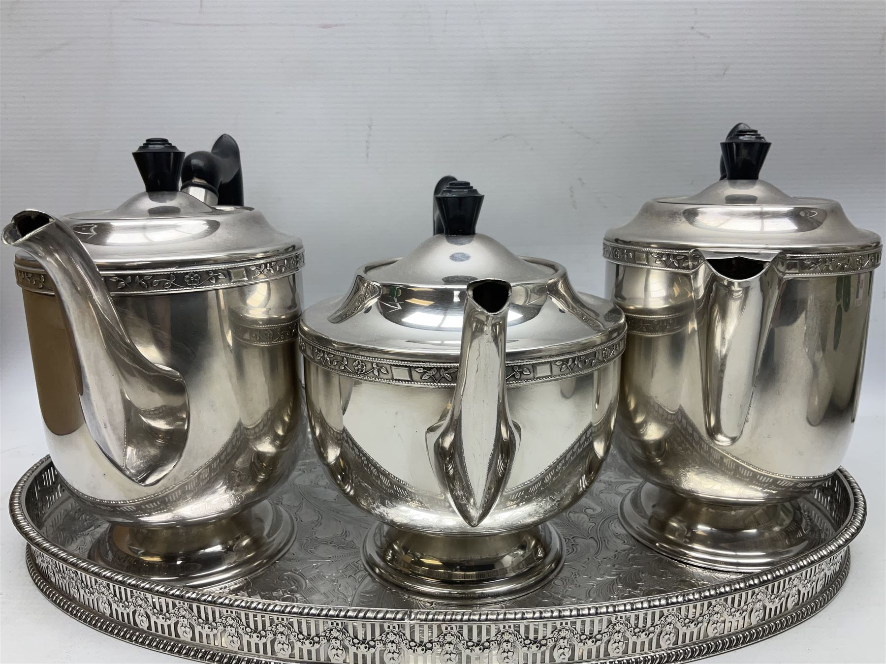 Viners of Sheffield silver-plate tea/coffee wares, the rims decorated with bands of flowers, and chased oval tray with swag decorated gallery, L39cm