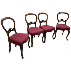 Set of six Victorian rosewood dining chairs, the balloon back carved with foliage scrolls, cartouche carved middle rail with extending scrolls, the seats upholstered in pink fabric, on carved cabriole supports with scrolled terminals 
