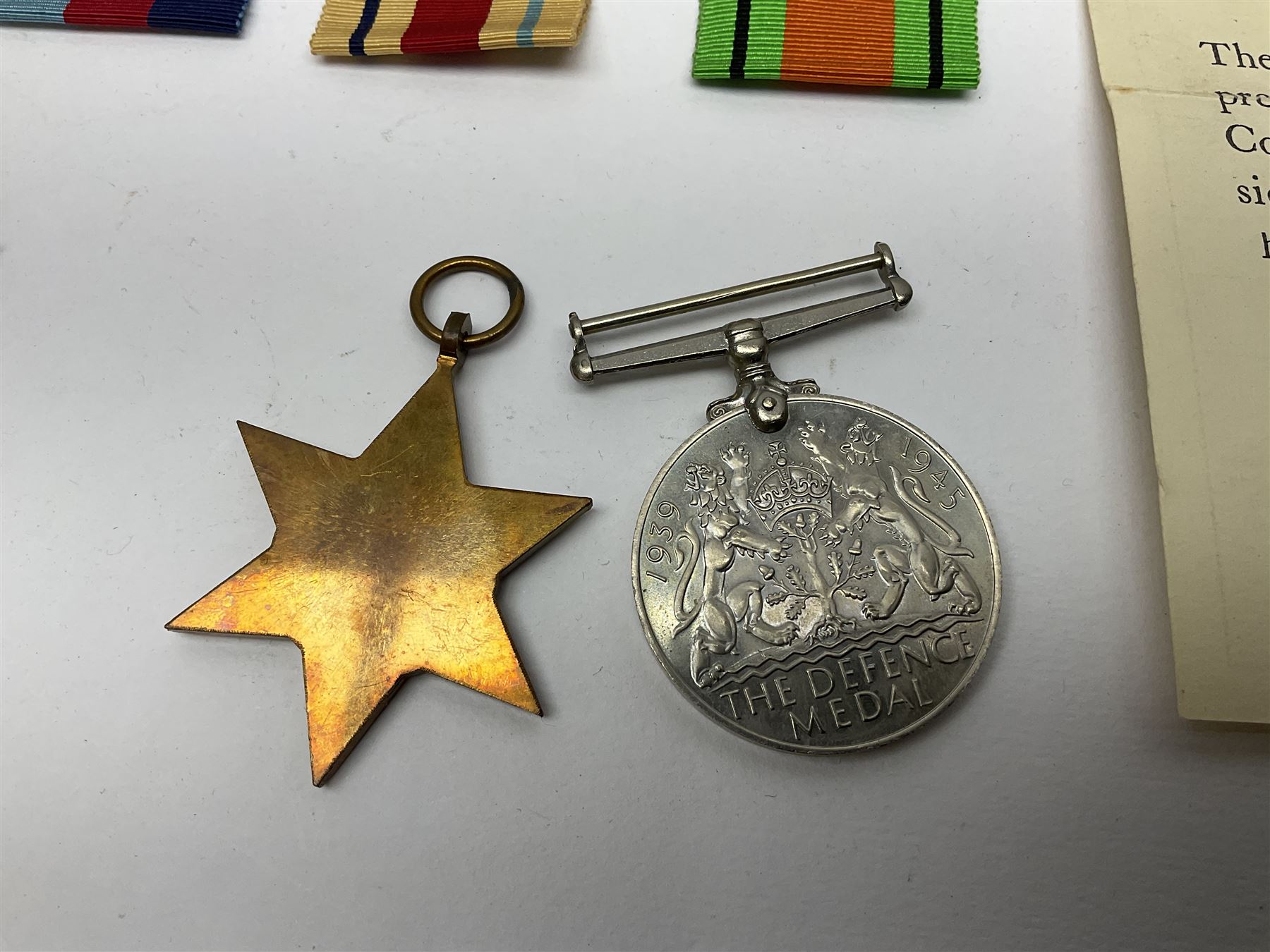 Twelve WW2 medals comprising four 1939-1945 war medals, four Defence medals, three 1939-1945 Stars and Africa Star; all with ribbons; some as groups in two issue boxes with slips