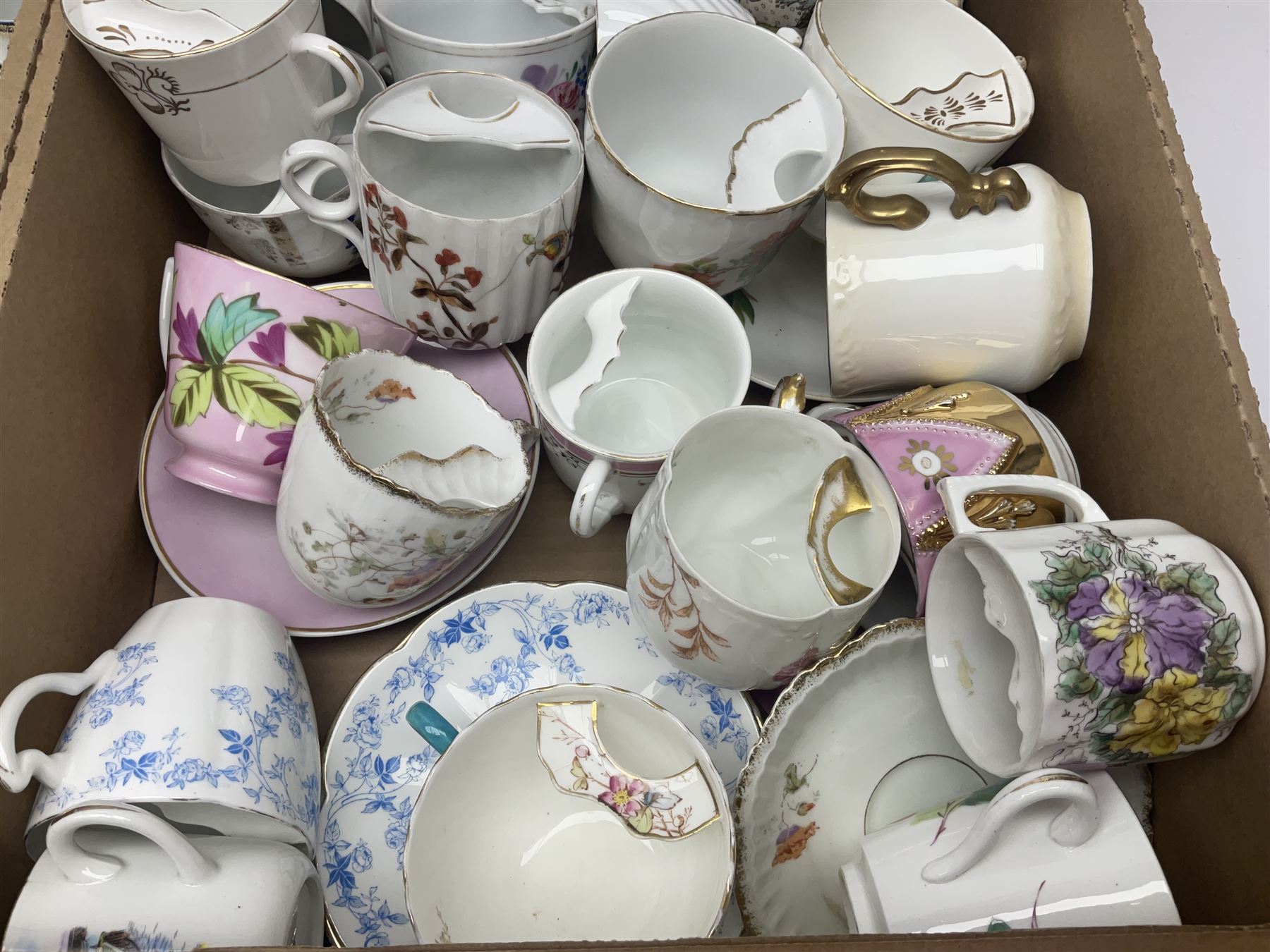 Collection of 19th century and later moustache cups, mostly with matching saucers, including hand painted examples