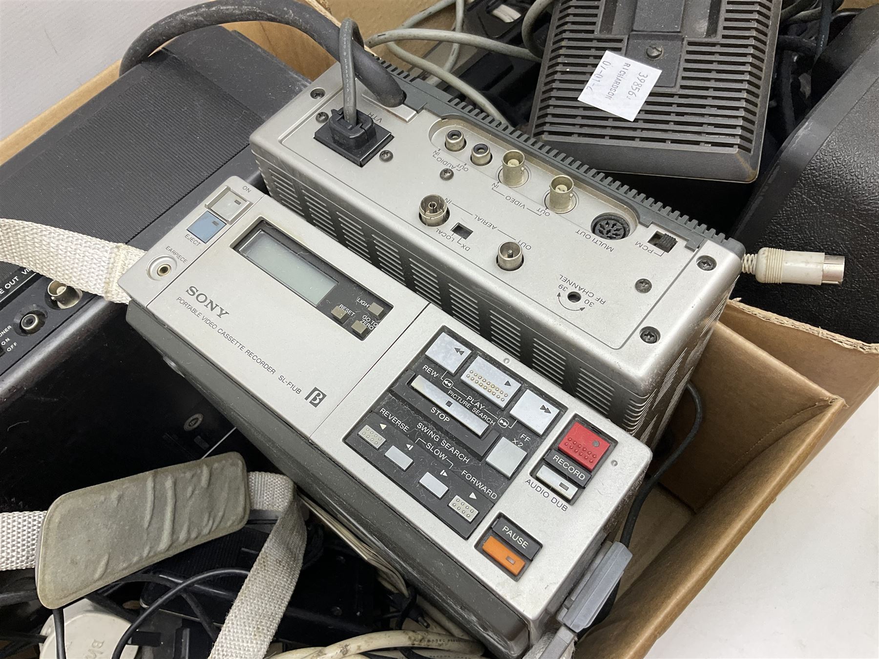 Cased Sony 'Trinicon' HVC-200P video camera, Sony Betamax portable video cassette recorder, cased Sony Video 8 CCD-V100E video camera, Sony SL-F1UB portable video cassette recorder, two Sony AC power adaptors etc