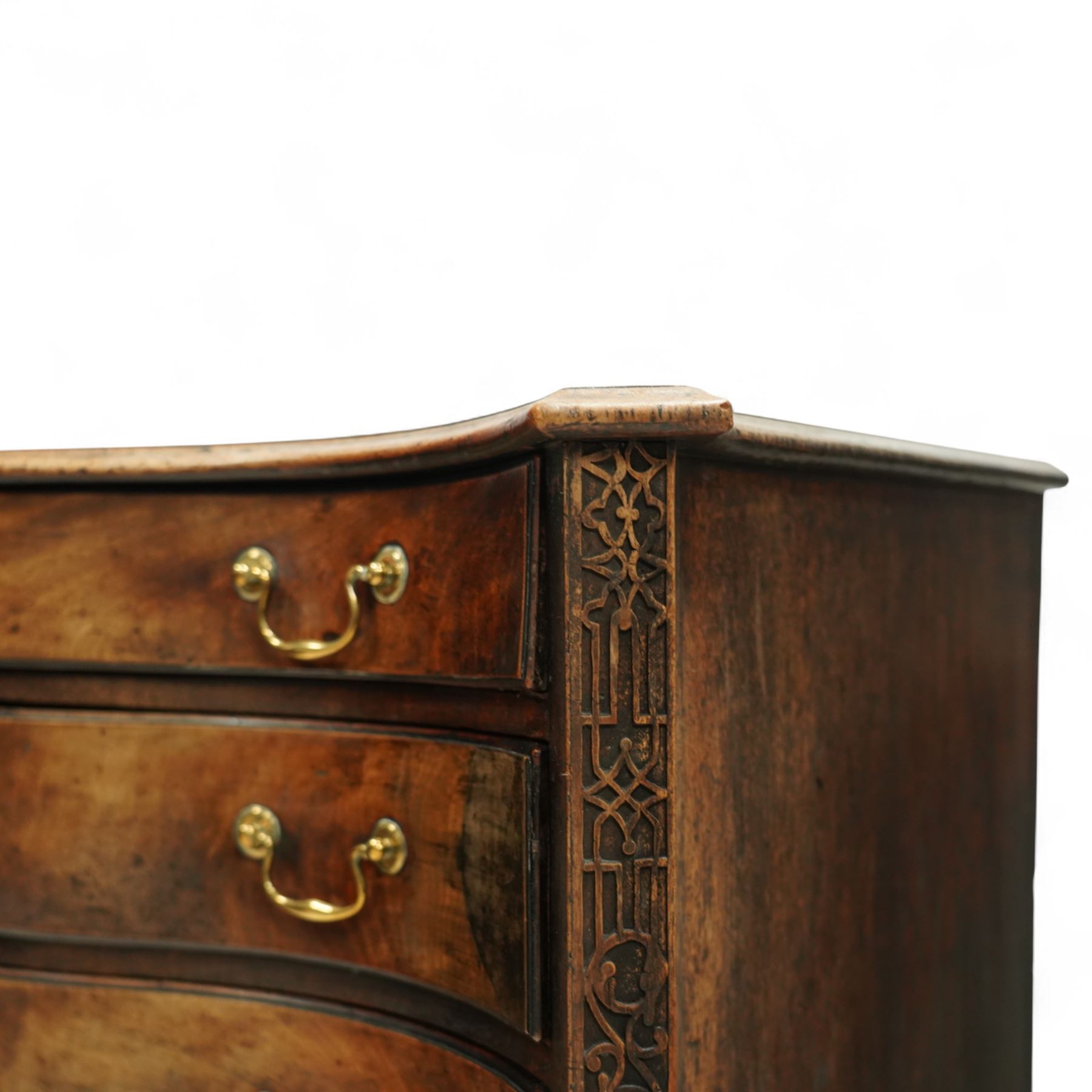 George III Chippendale period mahogany serpentine-fronted chest, shaped top with moulded edge over a deep serpentine outline with four graduated drawers, the canted corners decorated with blind-fretwork geometric decoration, fitted with brass swan-neck handles, lower moulded edge on bracket feet, circa 1760-1770