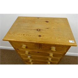  Solid pine chest of two short and five long drawers, turned wooden handles and shaped plinth, W66cm, H107cm, D42cm  