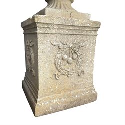 Pair of quality Neoclassical design Haddonstone cast stone garden urns, the globular  body decorated with relief foliate festoons and fruiting motifs, over a fluted socle, the rectangular pedestals with relief foliate wreaths and ribbon garlands