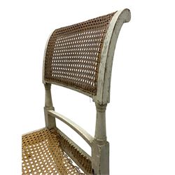 Collection of Regency dining chairs - set of four Regency painted beech dining chairs, with cane seat and back, on collar turned supports with splayed feet (W46cm, H84cm); a pair of Regency ebonised dining chairs (W47cm, H77cm); and a single Regency dining chair, the cresting rail painted with floral cornucopias and central putto vignette, X-frame back over cane seat, on collar turned front supports painted with foliage (W46cm, H84cm) (7)