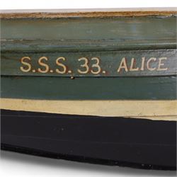 Two wooden fishing coble models, comprising SE31, with rudder, painted in blue, white and red and SSS.33 'Alice', painted in green, black and yellow, largest H16cm, L70cm