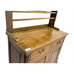 19th century and later oak dresser, moulding cornice a pierced and shaped frieze, over two open plate shelves above a base fitted with two drawers with brass swan neck handles, over panelled twin cupboard with single shelf, cantered corners on bracket feet