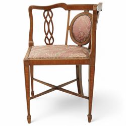 Edwardian inlaid mahogany corner chair, shaped cresting with satinwood band over interlaced splats, upholstered in floral pattern fabric, on square tapering supports with spade feet united by X-stretcher 