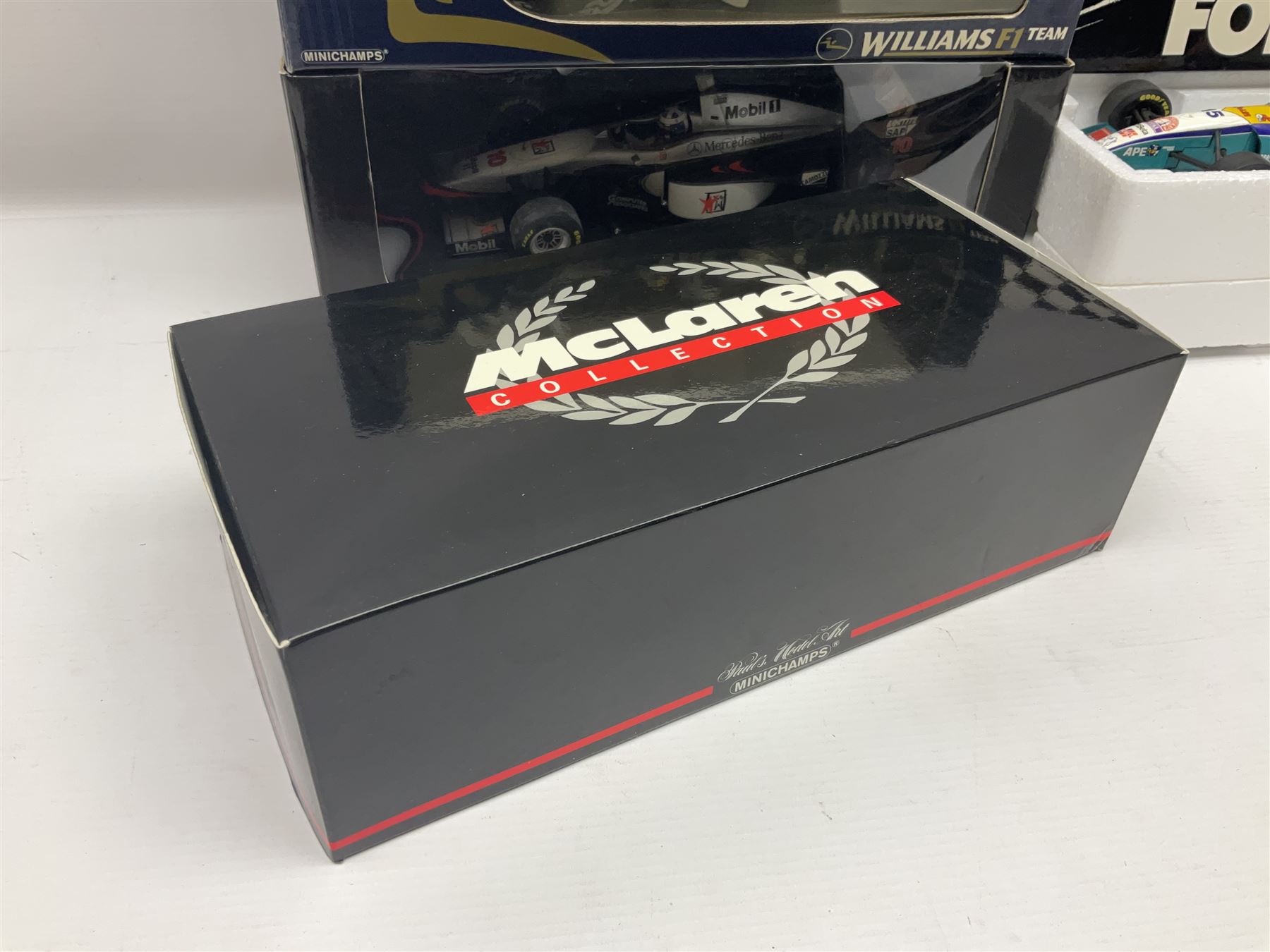 Four Minichamps 1:18 scale die-cast racing cars - Williams F1 Team BMW FW26 R. Schumacher; McLaren Mercedes MP4-12 D. Coulthard; McLaren Mercedes MP4-13 M. Hakkinen; and Formel 1 Jordan peugeot EJR 195 E. Irvine; all boxed (4)