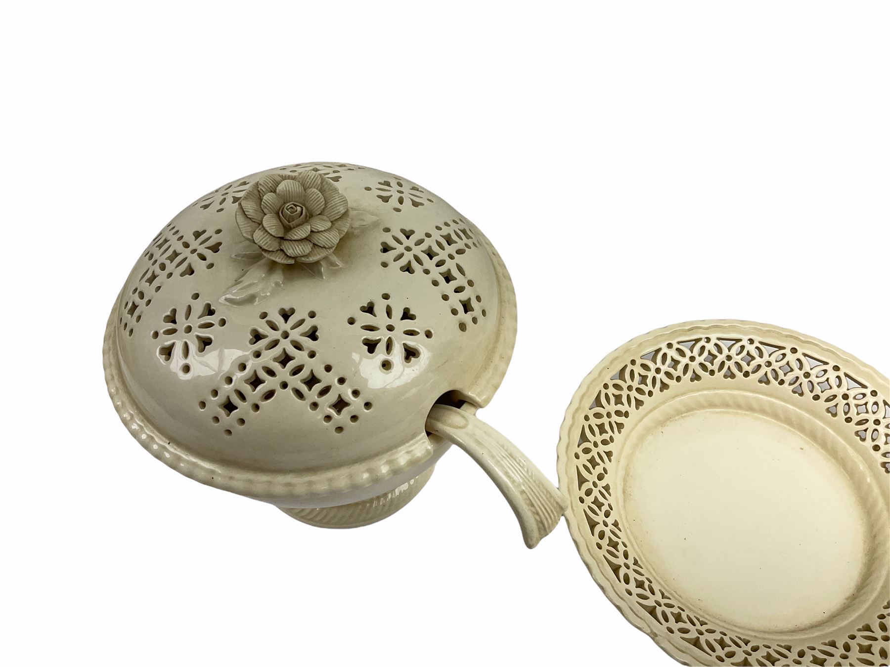 20th century Leeds creamware, comprising chestnut basket and stand, small tureen and cover, ladle, and associated stand, candlestick with stem modelled as a dolphin, teapot, tureen and cover in the form of a melon with fixed stand, and toast rack (toast rack a/f), each with impressed mark beneath. 