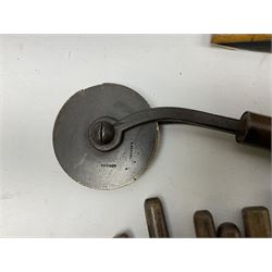 Thirty-one bookbinder's brass number and letter stamps, predominantly with beech handles, together with a bookbinder' decorative fillet roll, with brass triple line wheel stamped E. Menuel London, with wood handle, and two ink blotters