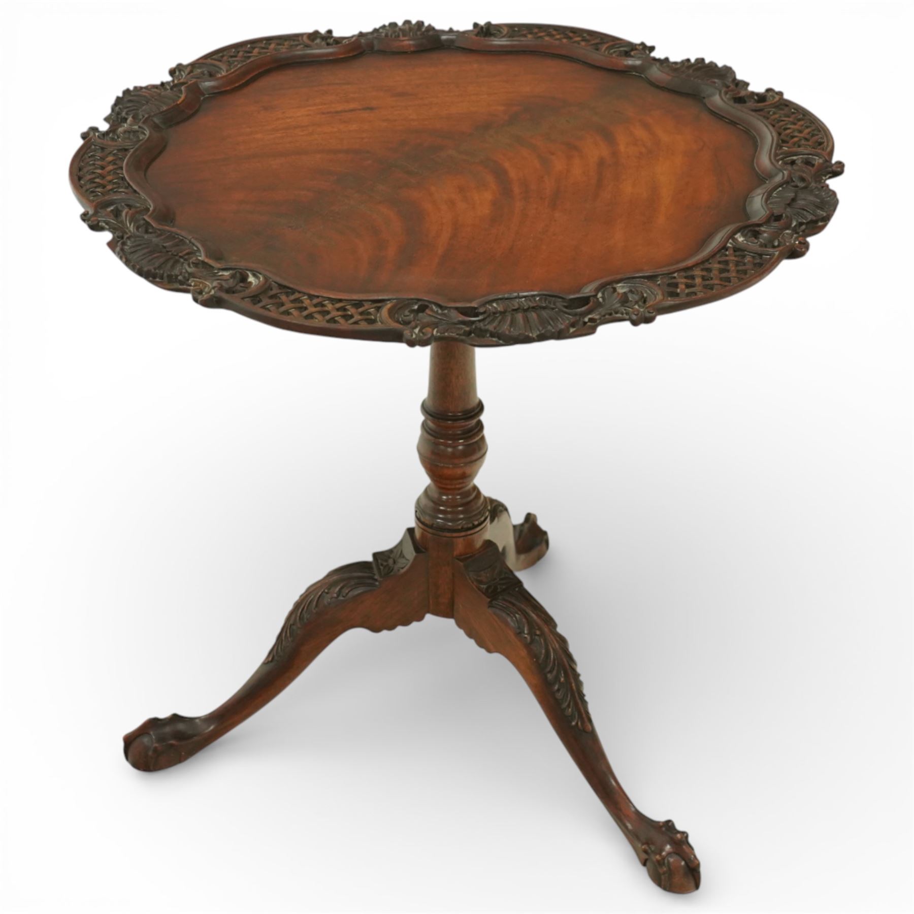Late 19th century Rococo Revival mahogany occasional table, with shaped circular top with ornate lattice-pierced edge, decorated with pierced scallop motifs and acanthi, raised on a birdcage movement over turned pedestal, terminating to foliate-moulded tripod base with ball and claw feet