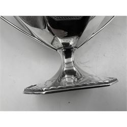 Victorian silver four piece tea service, comprising teapot, teapot stand, twin handled open sucrier and milk jug, each of octagonal form with foliate bud border and engraved decoration including crest to canted panels, and vacant panels, the teapot with ivory finial to the hinged cover and later wooden handle, hallmarked Edward Barnard & Sons Ltd, London1896, teapot including finial H15cm, milk jug including handle H16cm, teapot stand W11.5cm

This item has been registered for sale under Section 10 of the APHA Ivory Act