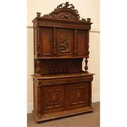 Early 20th century continental carved oak buffet cabinet, raised arched top with carved frieze, enclosed by three carved doors, centre door depicting man on horse back, two drawers with egg and dart detail, double cupboard below, W140cm, H237cm, D52cm  