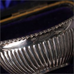 Pair of silver navette shape salts , cased Birmingham 1900 Maker Mitchell Bosley & Co., silver three piece condiment set, pair of silver cornucopia shape salts, silver upright photograph frame 17cm x 13cm and a pair of glass salts with silver rims