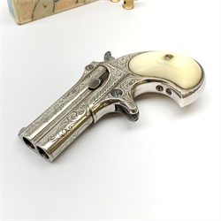 Factory engraved Remington .41 calibre double barrel over and under Derringer, the top of the barrels inscribed 'E. Remington & Sons Ilion. N.Y. Elliot's Patent Dec 12th 1865', with mother-of-pearl split grip, serial no.2695, L13cm overall; with receipt of purchase from Pete Holder dated 08/06/2008; reputedly from the Raymond Kendal collection (former Director of Interpol); with box of  dummy cartridges