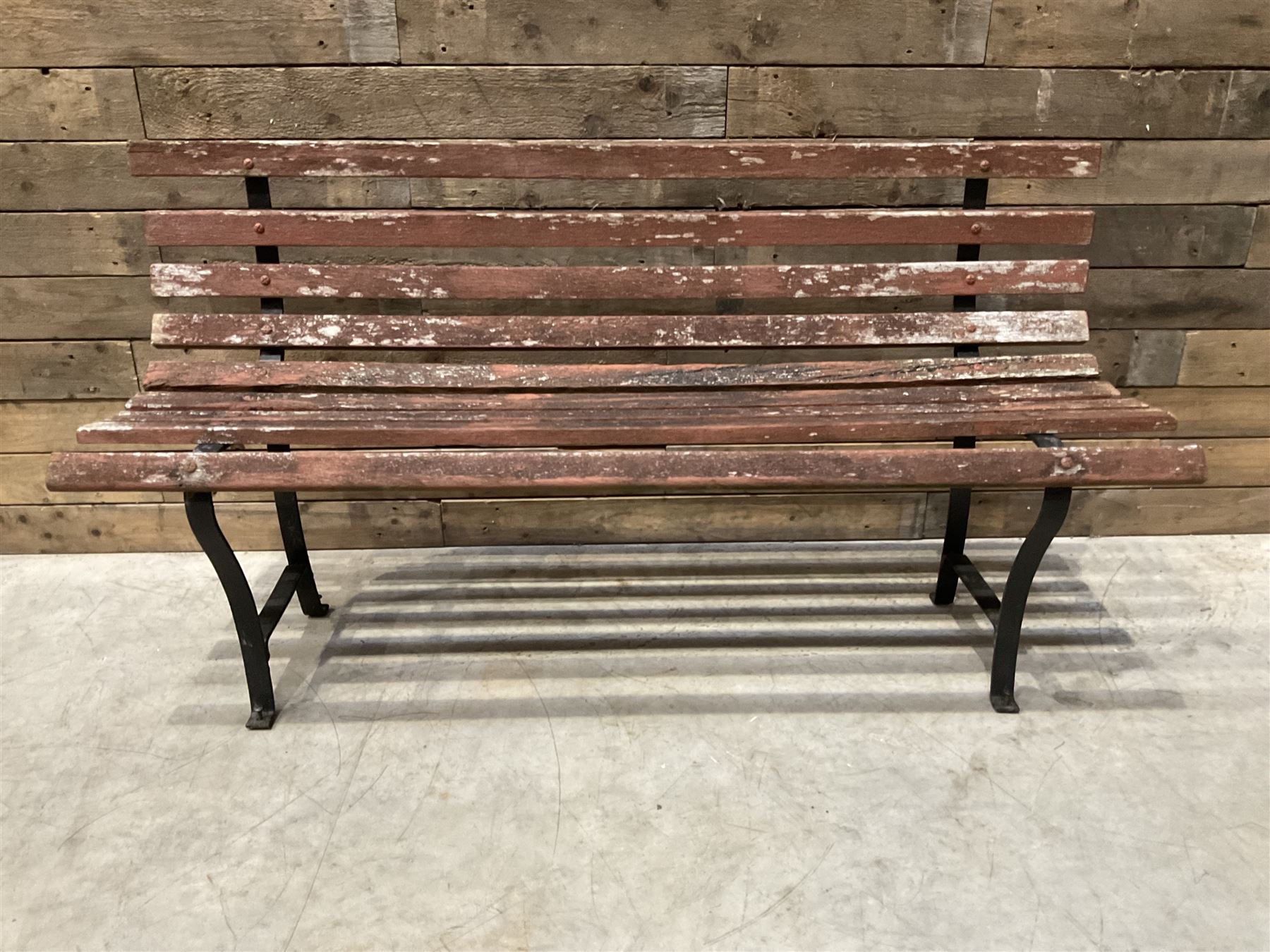 Wrought metal and wood slatted garden bench