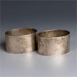 Two silver napkin rings, of oval form with engraved initials, both hallmarked