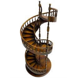 Miniature fruitwood spiral staircase, turned newel posts and balusters, rounded handrail, on circular moulded base