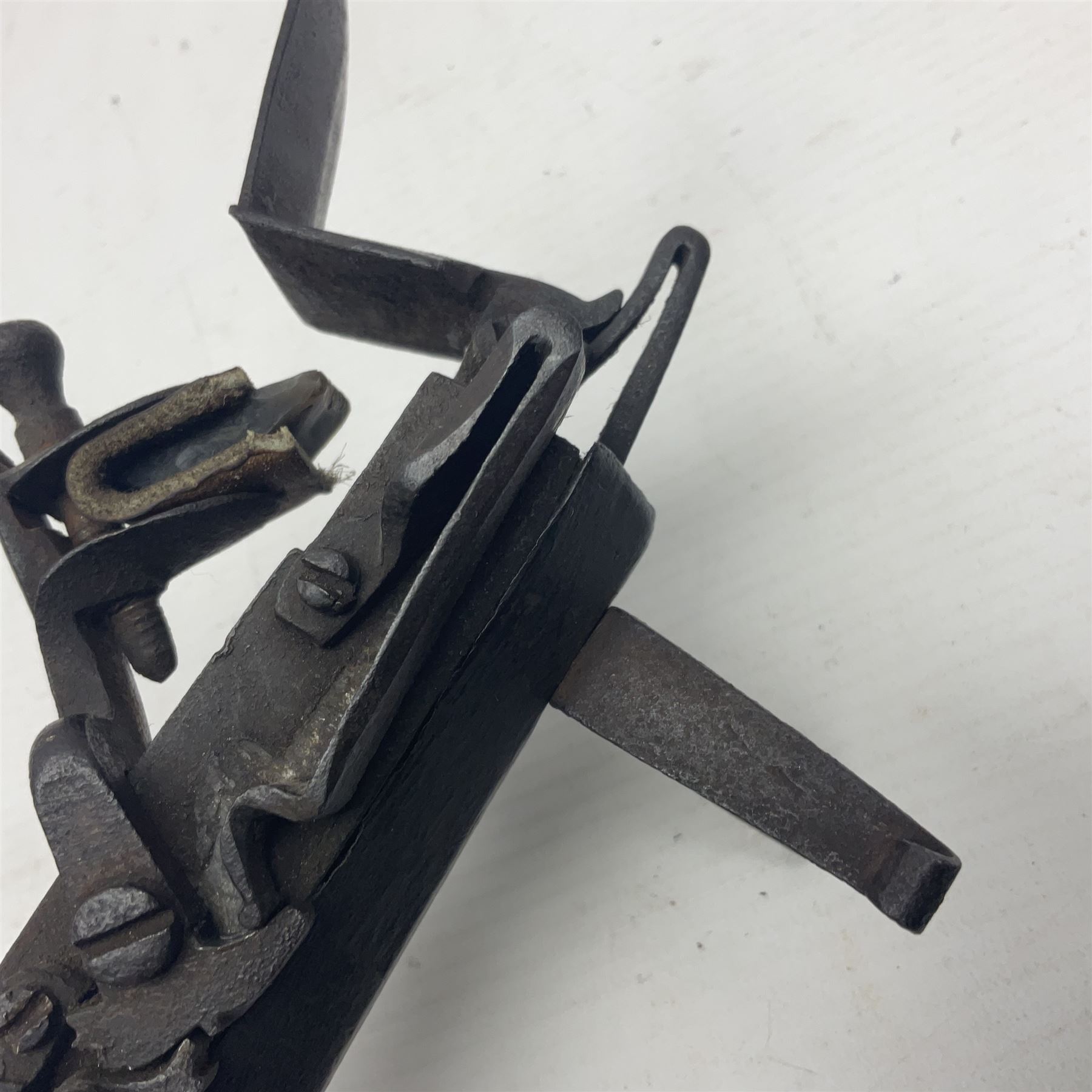 Late 18th/early 19th century flintlock tinder lighter, the steel box lock with hinged door to the left side, fruitwood butt with plain bar trigger, the left side set with a taper sconce and bipod front support, L21cm.