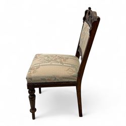 Victorian walnut set of four dining chairs, the shaped and carved top rails with central flowerhead and scroll decoration above upholstered backs and seats in floral woven fabric, brass stud trim, on ring turned front supports