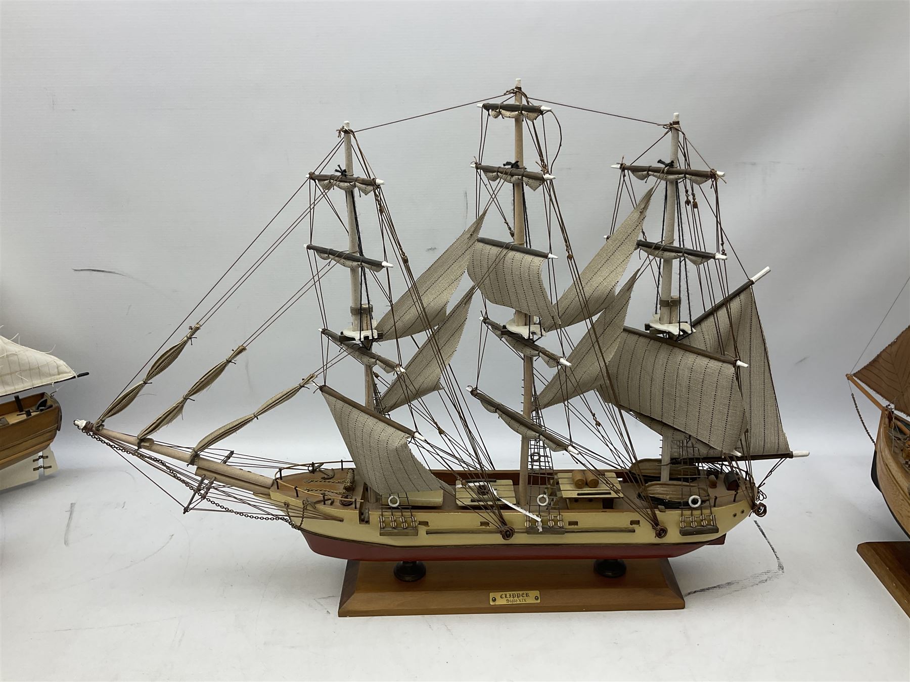 Eight model ships or boats including fishing boat with fish, nets and buoyancy aid, two mast sailing ship complete with cannons, two mast yacht with detailed rigging and life boat etc, the largest L72cm, H60cm